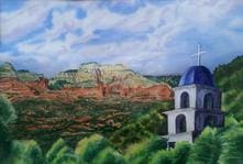 A painting of the desert and mountains with a church in the foreground.