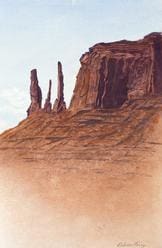 A painting of three rock formations in the desert.