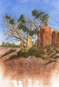A painting of a tree and ruins in the desert.